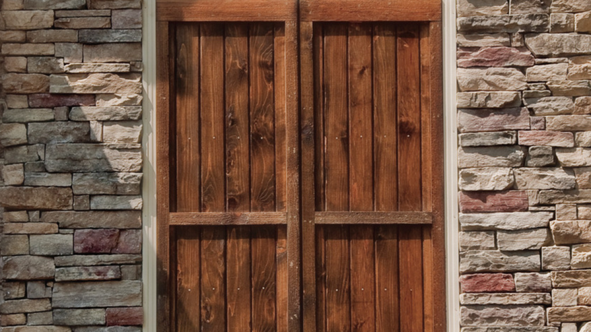 wooden shutters on stone wall