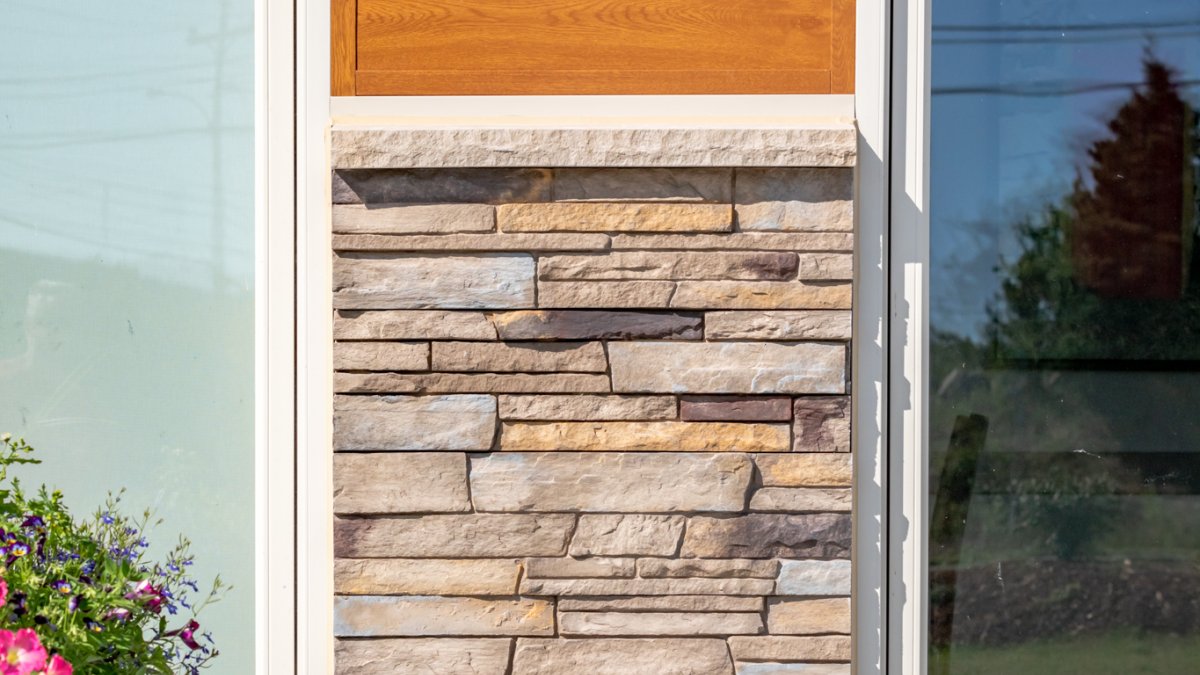two-toned building with window treatments and wooden and stone accents