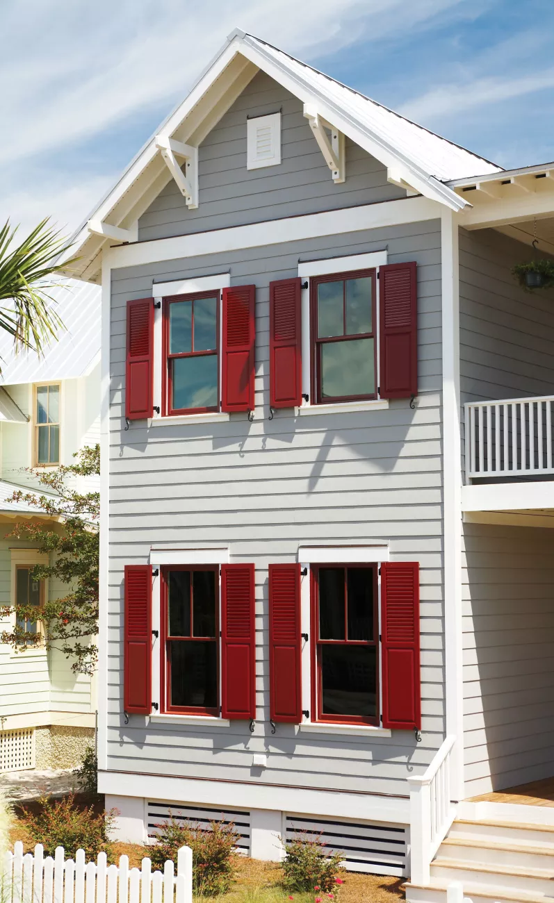 two story home with combination shutters