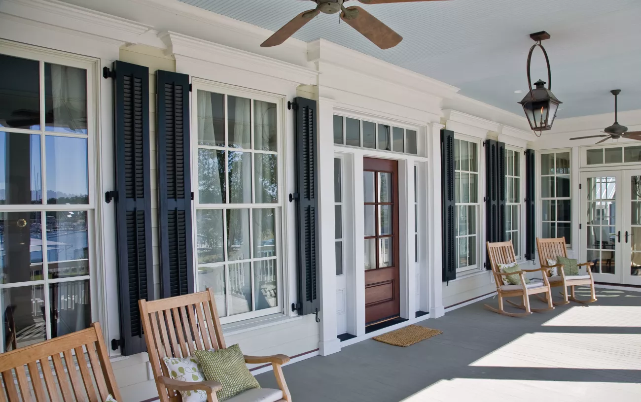 front porch with black open louver shutters