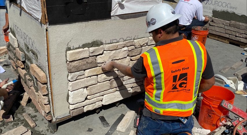 Contrator installing stone